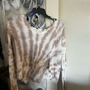 This is a pinkish mauve colored cropped sweater